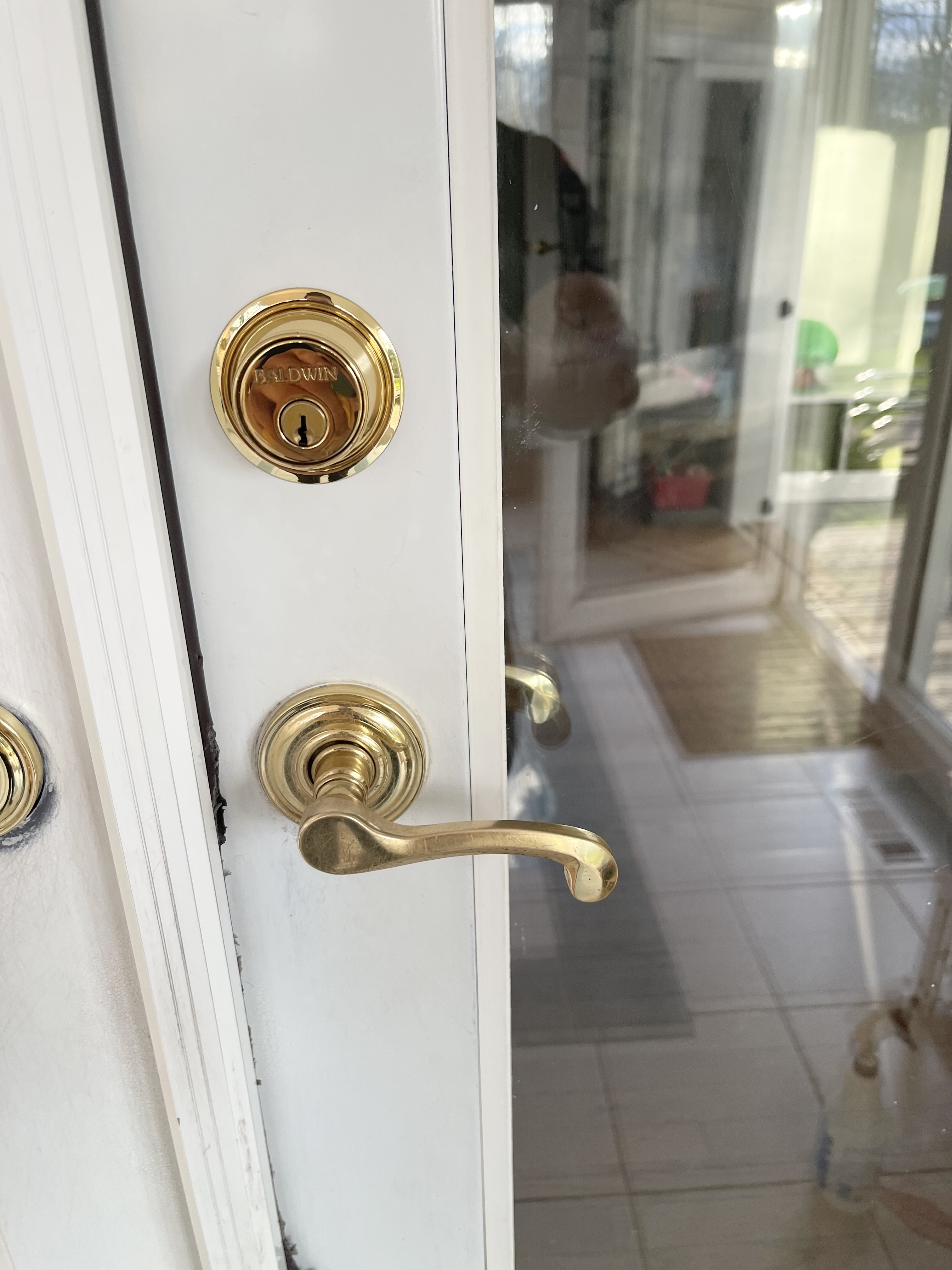 Front door handle and glass shining after recently being deep cleaned.