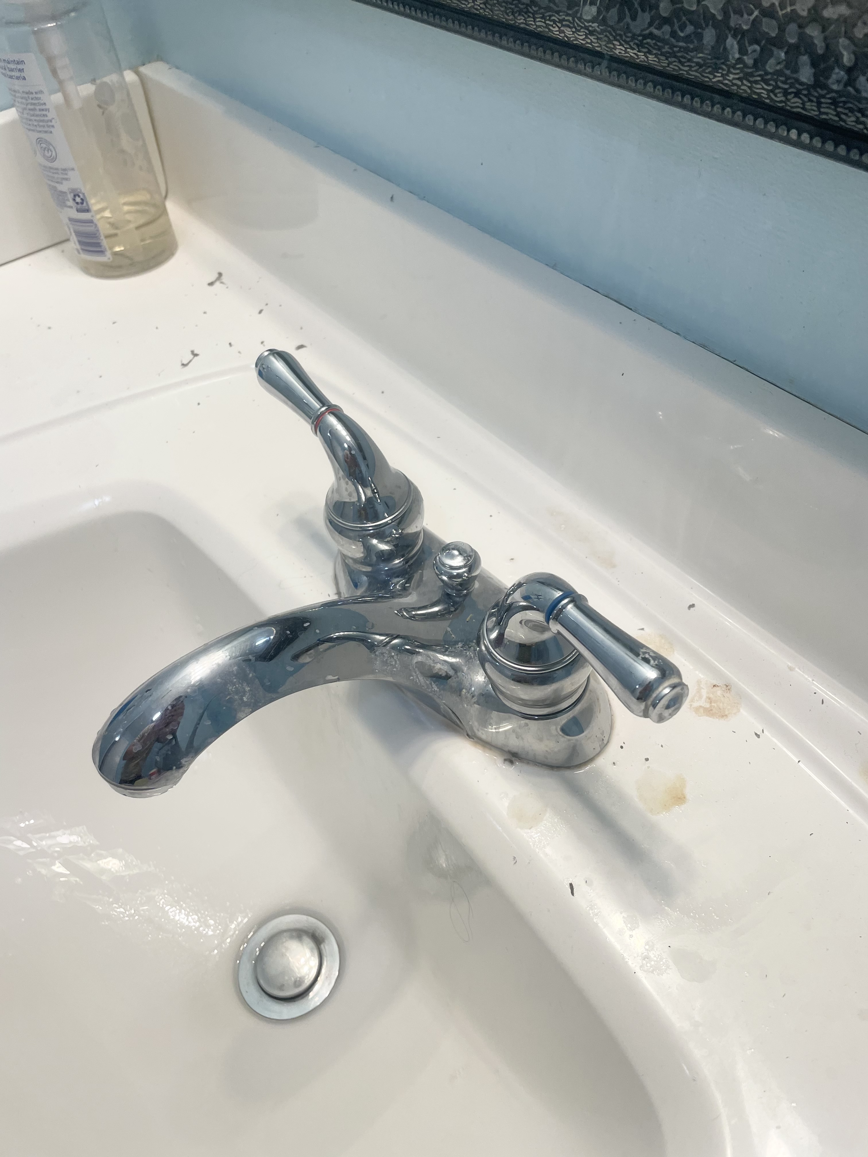 A dirty bathroom sink in a residential home.