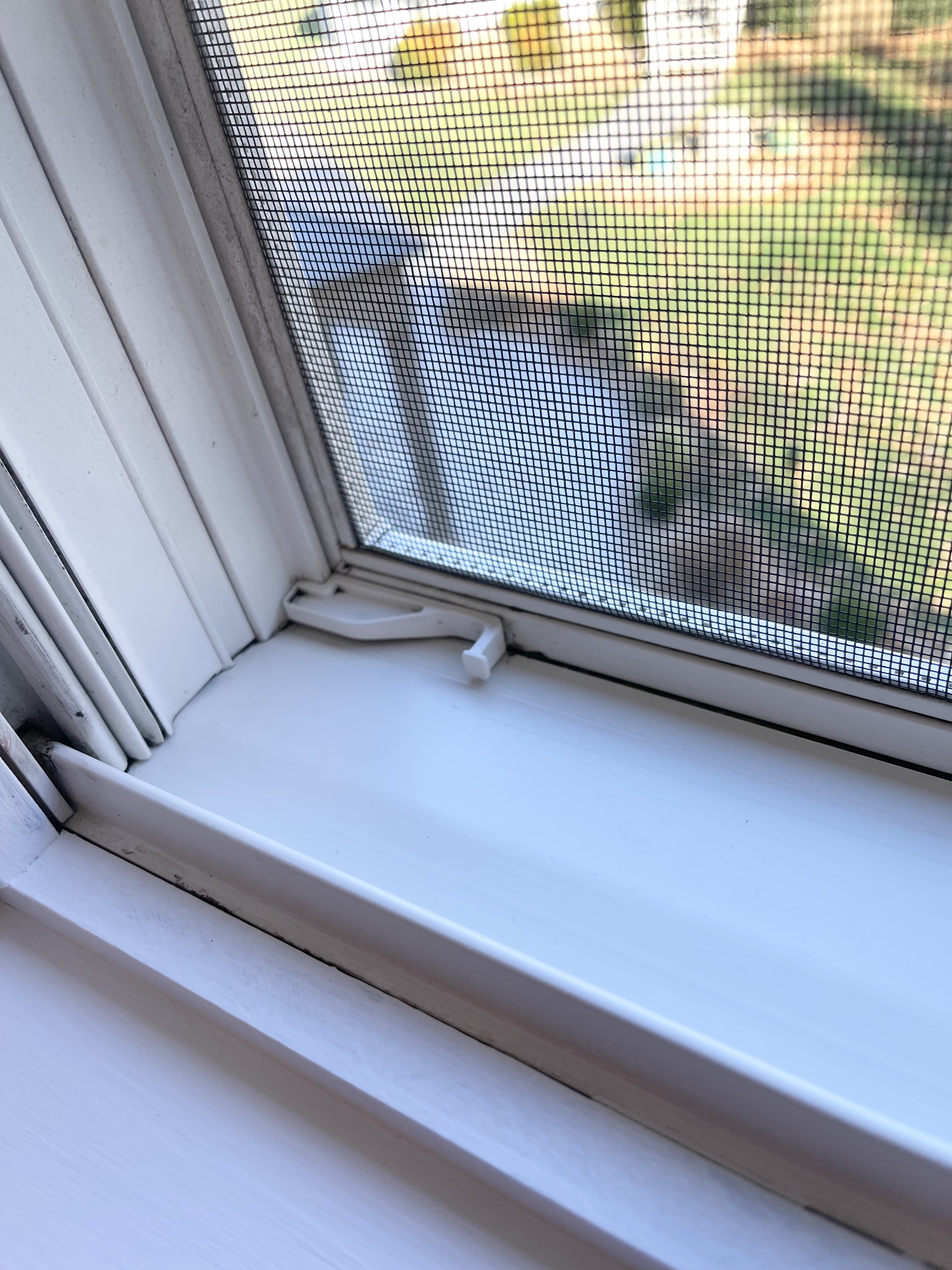 Close up of a freshly scrubbed and cleaned window track and sill in an office.